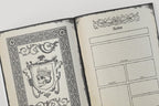 Open dnd notebook with decorative skull design on one page and faction pages on the other