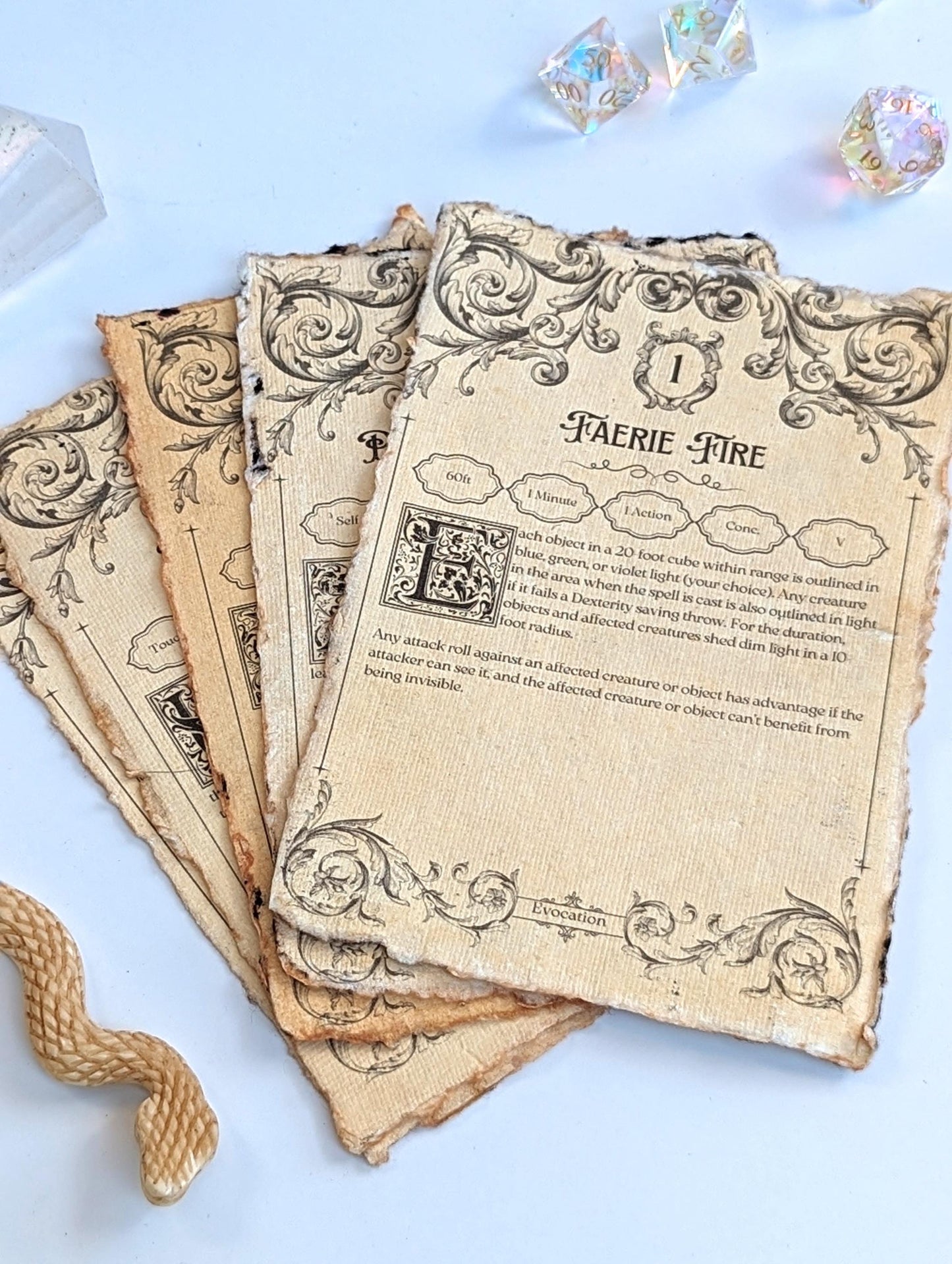 Vintage-style spellbook pages with decorative text and illustrations next to dice