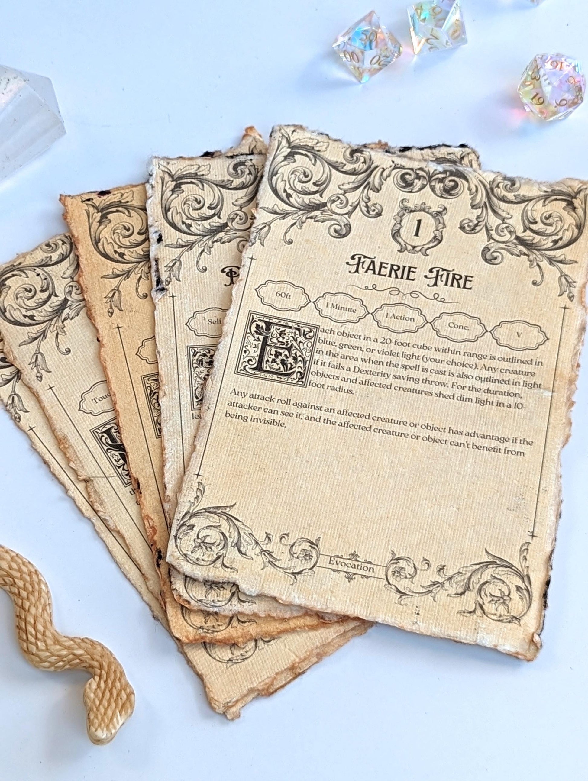 Vintage-style spellbook pages with decorative text and illustrations next to dice