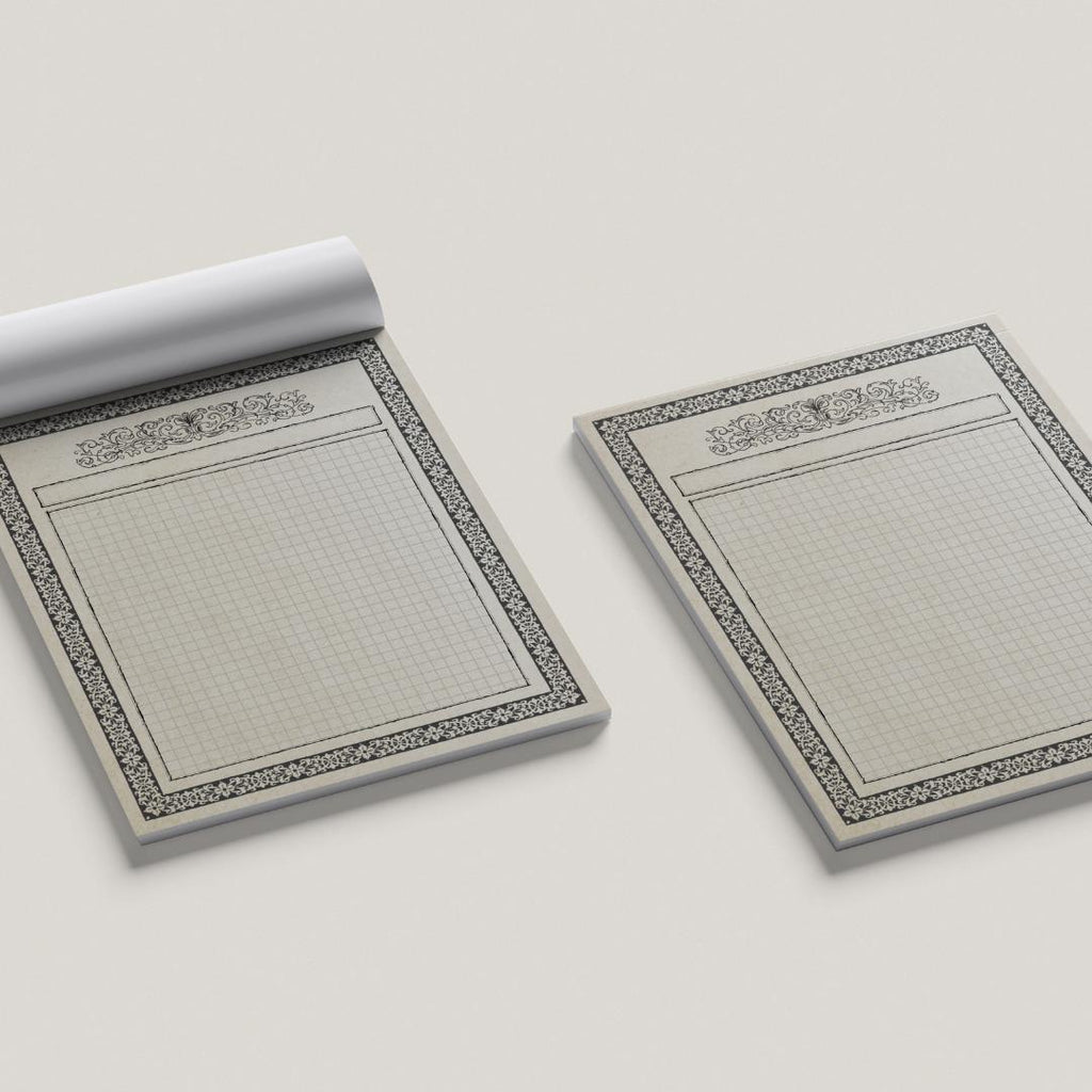 Two ttrpg map pads with decorative borders on a light gray background