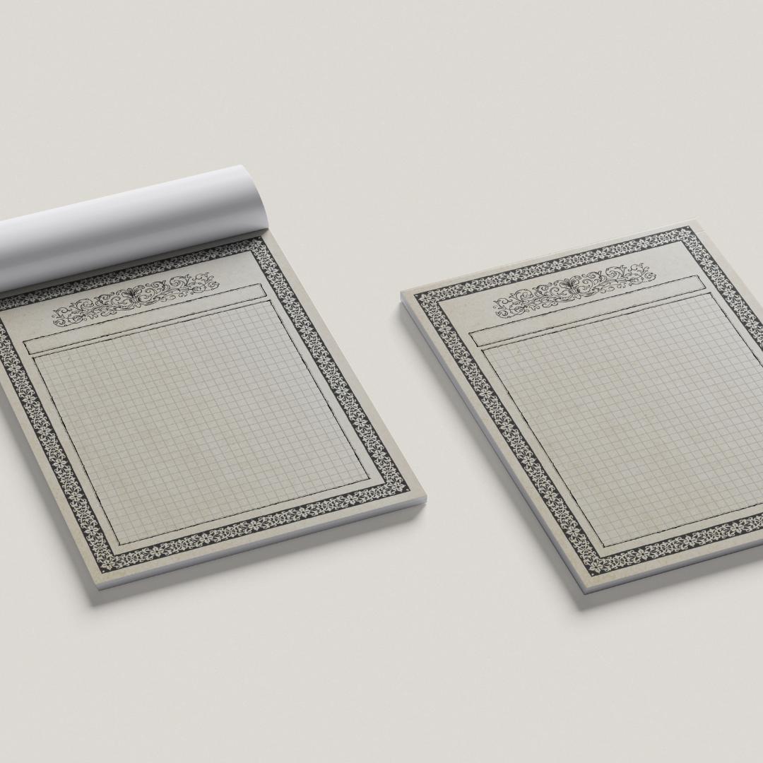 Two ttrpg map pads with decorative borders on a light gray background