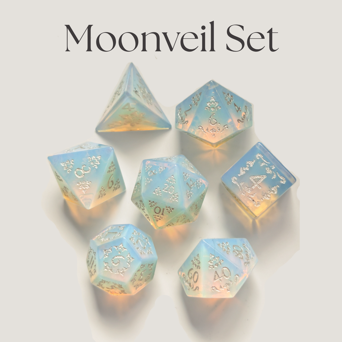 A set of seven translucent iridescent d20 polyhedral gaming dice with gold engraved symbols, arranged on a light beige background under the text 'Moonveil Set'.