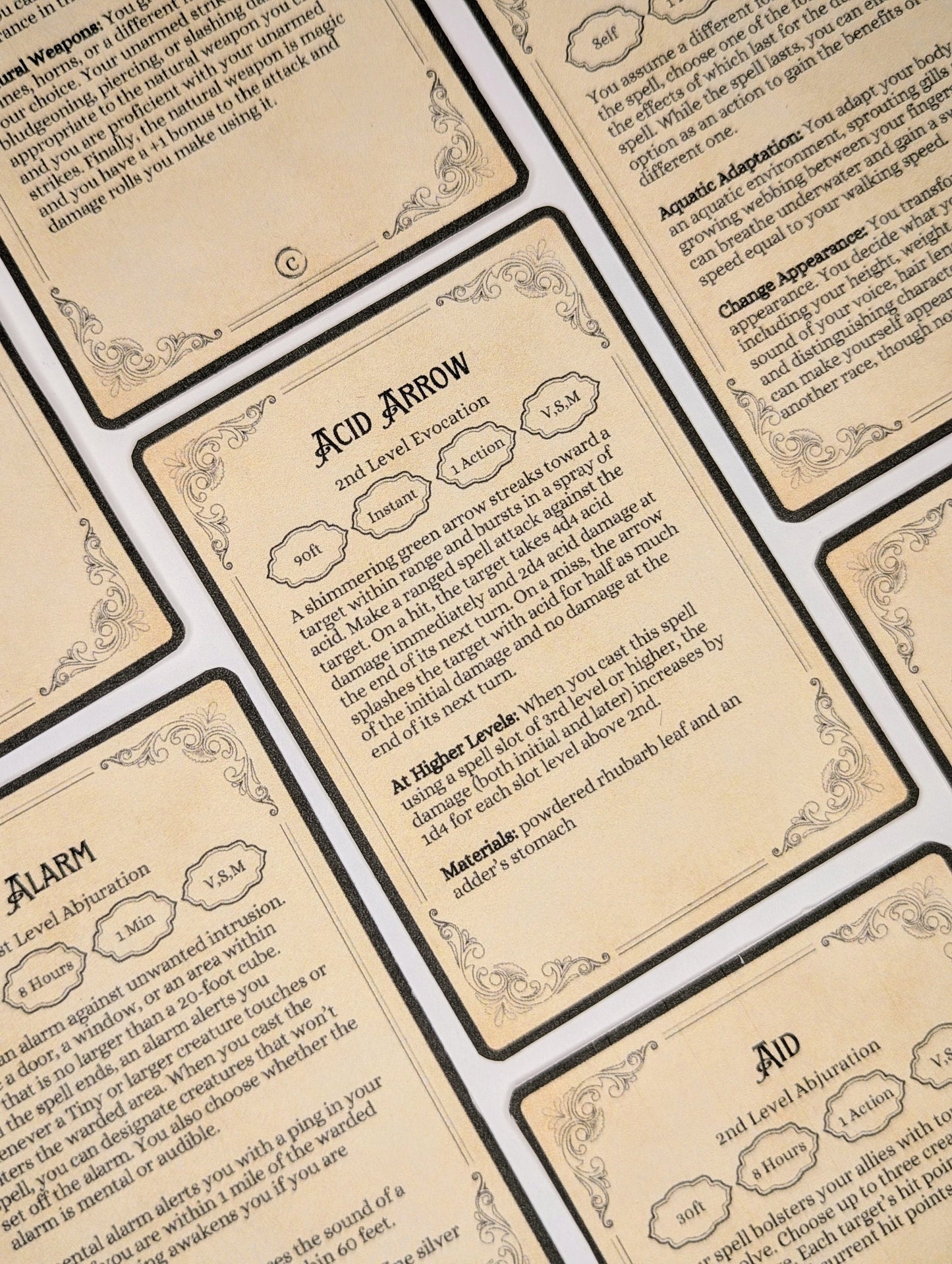 Close-up of fantasy dungeons and dragons spell cards with text and decorative elements.