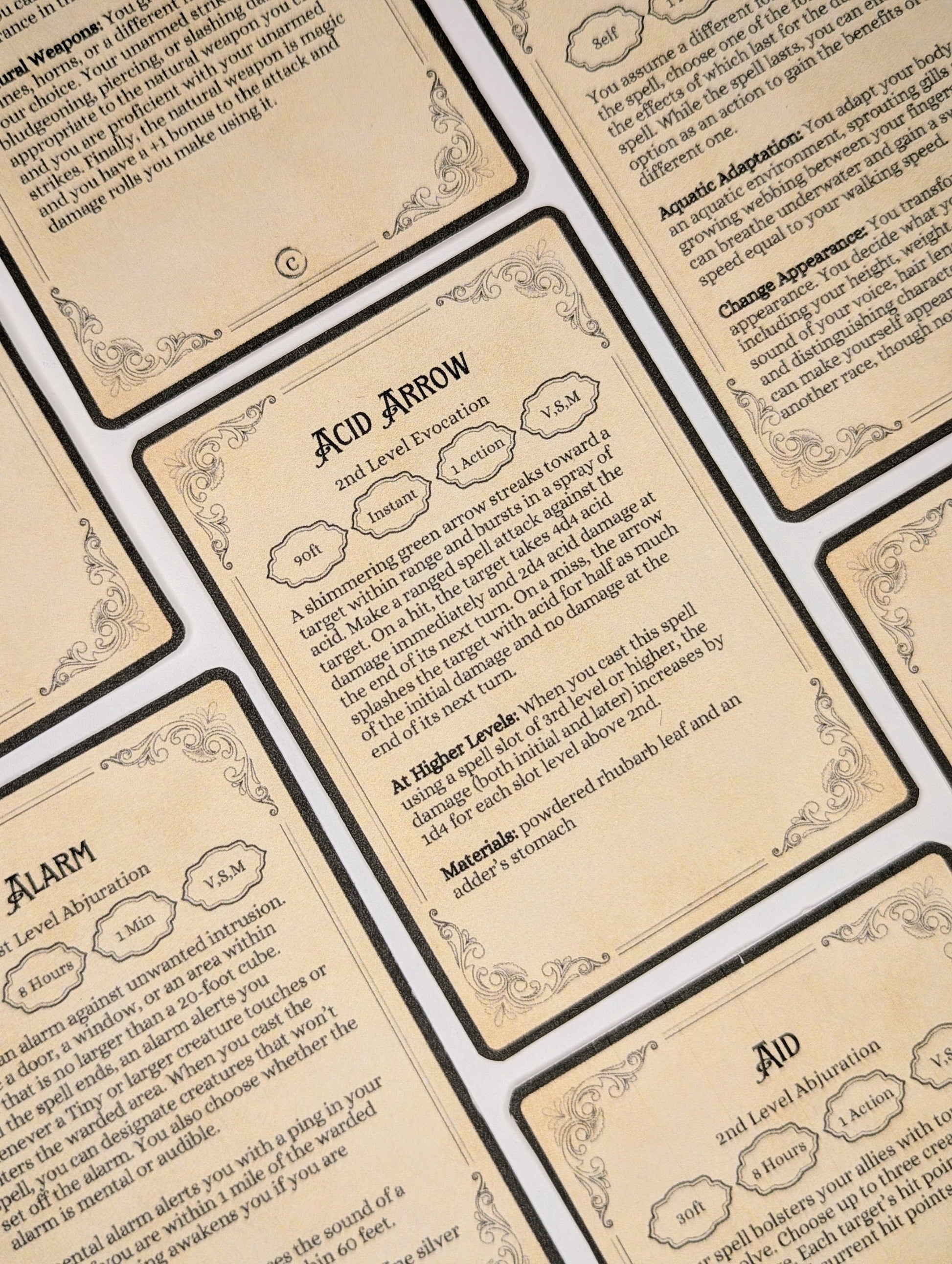 Close-up of fantasy dungeons and dragons spell cards with text and decorative elements.
