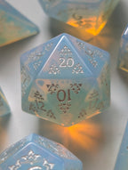 The Moonveil opalite D&D dice set with translucent blue tones and ornate silver numbering