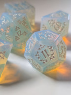 Detail view of The Moonveil opalite D&D dice with shimmering blue tones and silver numbering