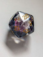 Close-up of The Nightbloom D20 with multifaceted gemstone cut, dark floral inclusions, and gold numbering