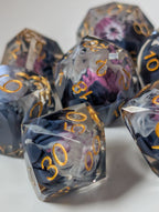 Detail view of The Nightbloom gemstone-cut polyhedral dice with smoky purple flowers and gold numbers