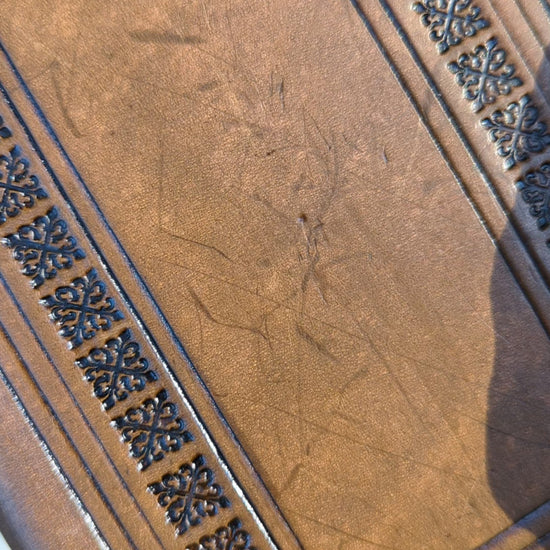 a video of a hand stamped leather dnd spellbook