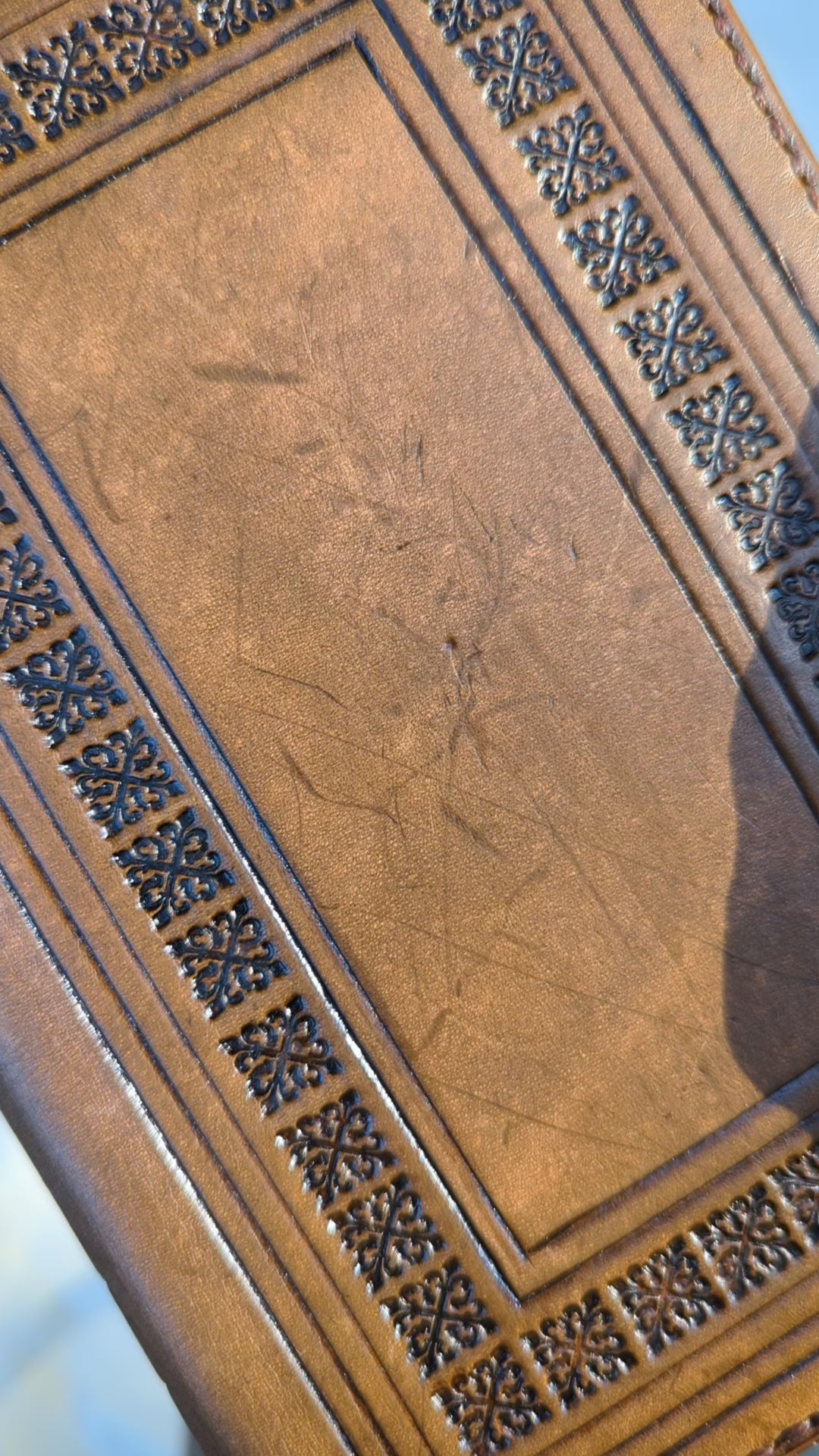 a video of a hand stamped leather dnd spellbook