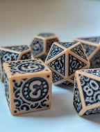 The Relic D6 and matching polyhedral dice with antique-inspired black detailing